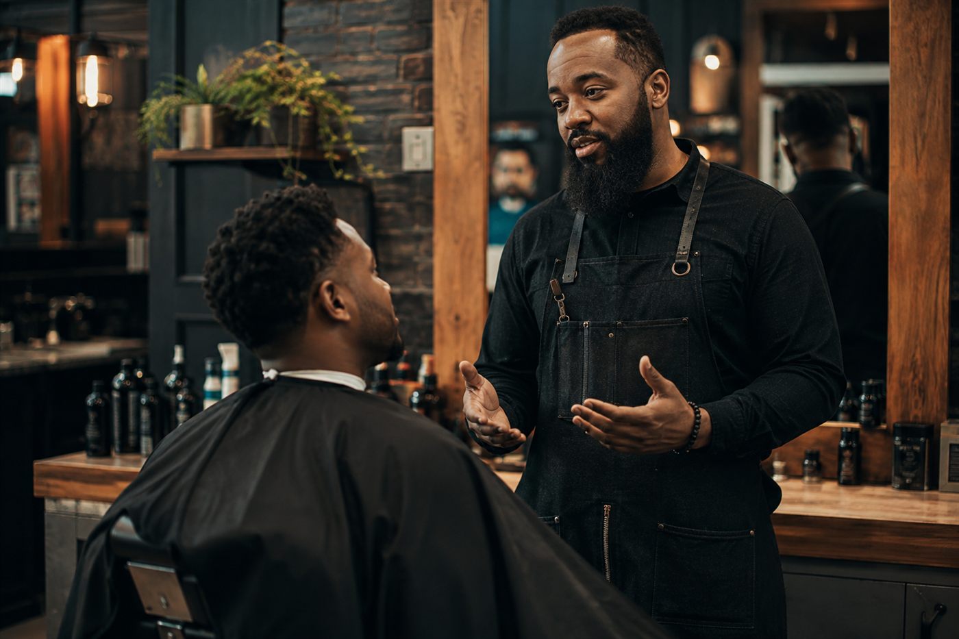 A barber talking a client through the cut before starting.