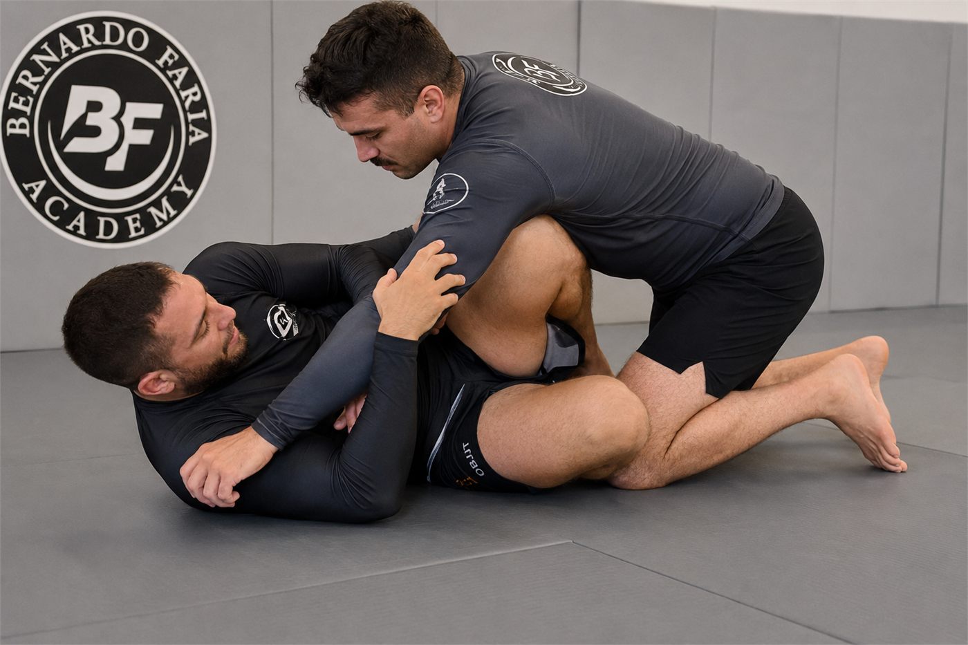 Two students training no-gi in rash guards.